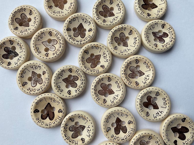 Close view of wood grain texture on 'Hand Made with Love' craft buttons.