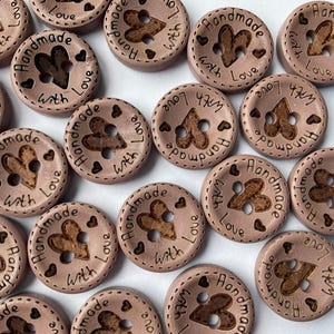 Round wood fasteners with etched love message for children's clothing. dusky pink brown colour sewing buttons with handmade with love heart etched