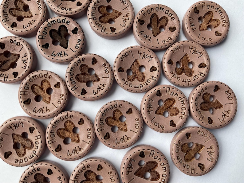 Round wood fasteners with etched love message for children's clothing. dusky pink brown colour sewing buttons with handmade with love heart etched