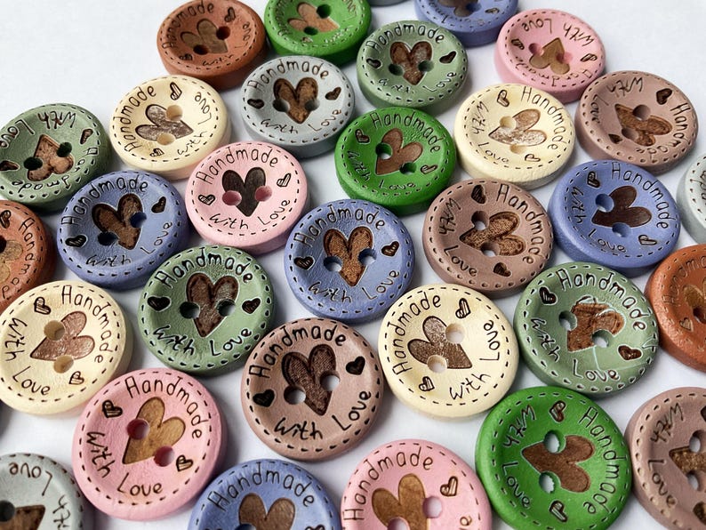 15mm wooden buttons with 'Hand Made with Love' text for knitting projects. Green, pink, cream, sage, grey, natural colours