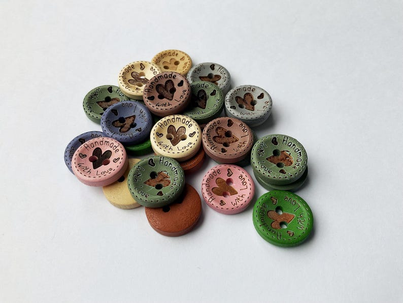 Creamy white and blue grey sewing buttons with 'Hand Made with Love' text.