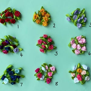 May include: Nine small, handmade ribbon flower arrangements in various colors, including red, orange, purple, pink, and blue, with green ribbon leaves. Each arrangement is numbered 1 through 9 on a light green background.