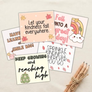 May include: Four square cards with inspirational text and autumn-themed illustrations. One card says Let your kindness fall everywhere with maple leaves. Another says Fall into a great day with a rainbow. Others feature text about kindness and growth.