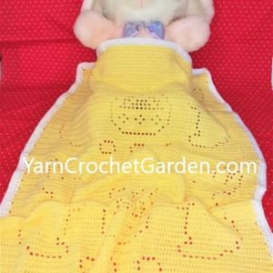 May include: A yellow crocheted baby blanket with a white border. The blanket has a crocheted design of a bunny rabbit. The blanket is lying on a red surface with white polka dots. The text "YarnCrochetGarden.com" is visible on the blanket.