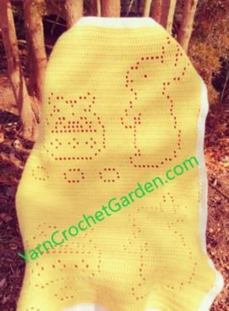 May include: Yellow crochet baby blanket with a white border and a red embroidered design of a bear, a bird, and a flower.
