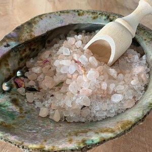 May include: Pink Himalayan salt bath soak in a green abalone shell with a wooden scoop.