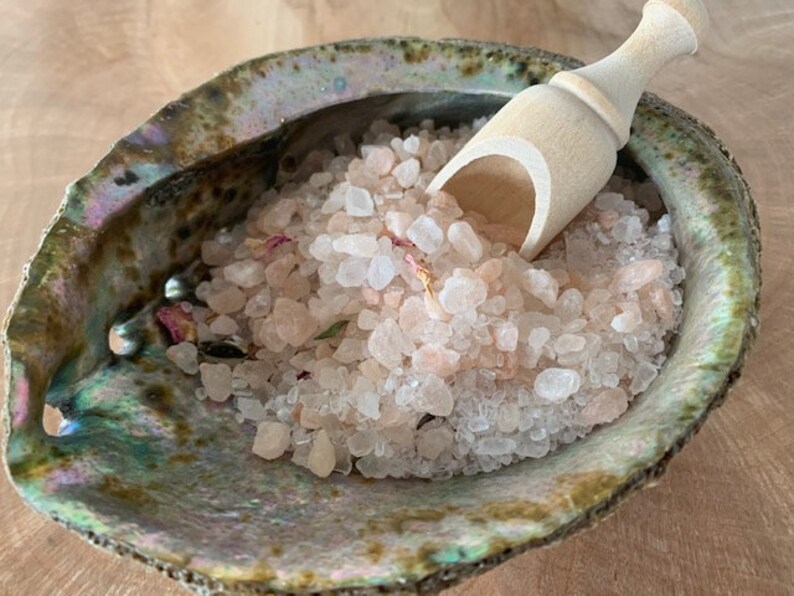 May include: Pink Himalayan salt bath soak in a green abalone shell with a wooden scoop.
