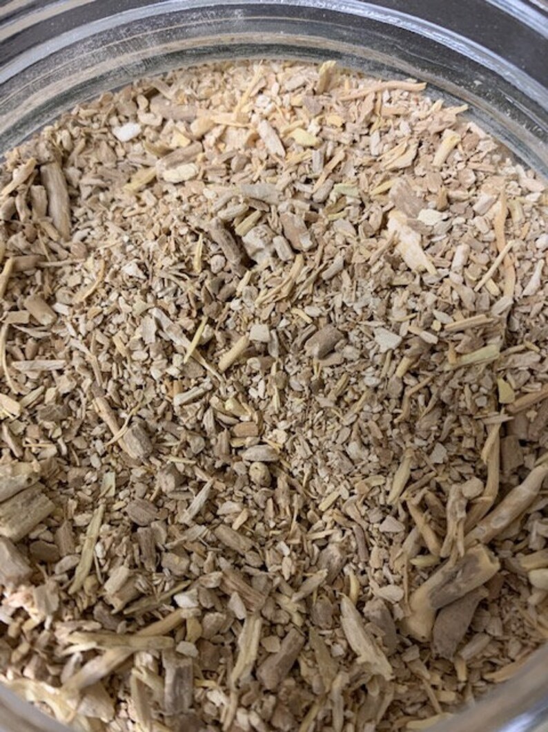 May include: Close-up of a jar filled with dried, light brown, and beige root pieces. The pieces are of varying sizes and shapes, some are long and thin, others are short and thick.