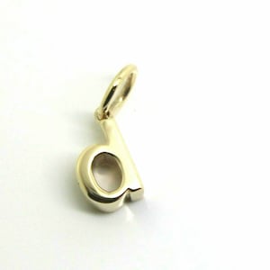 May include: Gold charm in the shape of the letter 'd'.