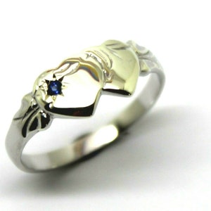 May include: A silver ring featuring two interlocked heart-shaped designs. The ring has a small blue gemstone set in the centre of the hearts.