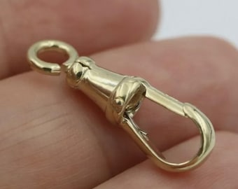 May include: A gold-toned metal watch chain clasp with a swivel hook and a spring-loaded clasp.