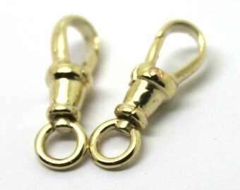 May include: Two gold-toned metal watch chain clasps with a round loop on one end and a hook on the other end.