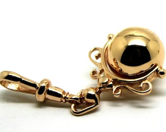 May include: A gold-toned pendant with a round, swiveling orb attached to a decorative, ornate bail. The pendant has a loop at the top for attaching to a chain.