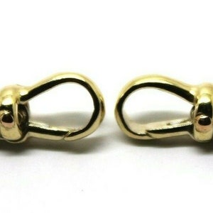 May include: Two gold-tone metal watch chain clasps with a round loop on one end and a hook on the other end.