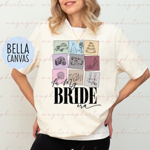 May include: A white t-shirt featuring a graphic design of a bride-themed collage. The collage includes images of a wedding dress, a wedding cake, a bouquet of flowers, a pair of champagne flutes, and other wedding-related items. The text "In My Bride Era" is printed below the collage.