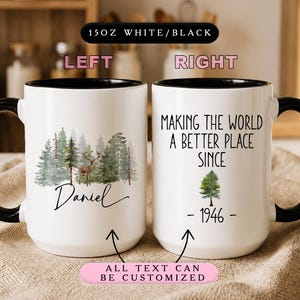 May include: Two 15 oz white ceramic mugs with black handles and rims. The left mug features a forest scene with a deer and the name Daniel. The right mug displays the text Making the world a better place since 1946 with a small tree graphic.