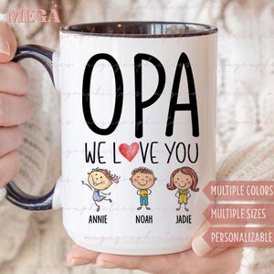 May include: White ceramic mug with a black rim and handle. The mug has a black and white graphic that says "OPA WE LOVE YOU" with three stick figures below the text. The stick figures are labeled "ANNIE", "NOAH", and "JADIE".
