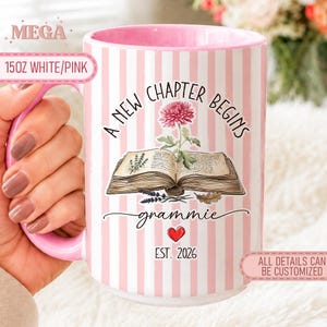 May include: A 425ml white and pink striped ceramic mug featuring an open book illustration with a pink flower, the text A NEW CHAPTER BEGINS, the word grammie in script, a red heart icon, and the text EST. 2026 printed on the front surface.