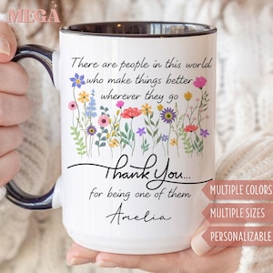 May include: White ceramic mug with a black interior and handle, featuring a floral design and the text "There are people in this world who make things better wherever they go. Thank You... for being one of them Amelia."