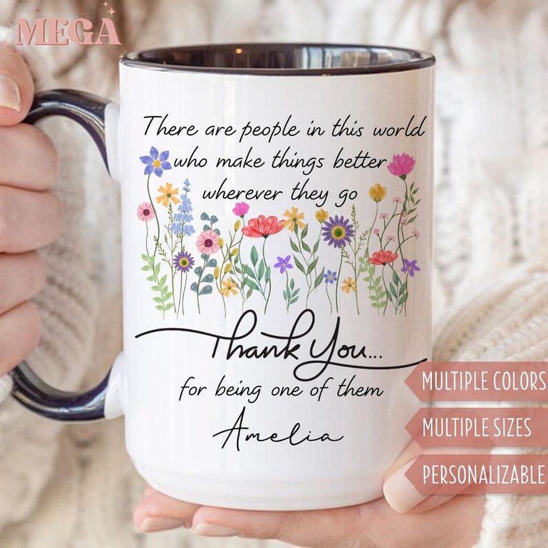 May include: White ceramic mug with a black interior and handle, featuring a floral design and the text "There are people in this world who make things better wherever they go. Thank You... for being one of them Amelia."