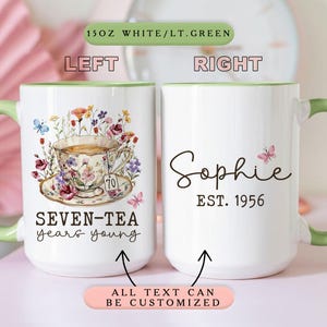 Può includere: Tazza in ceramica bianca con manico e bordo verdi. Il lato sinistro presenta un disegno floreale di tazza da tè con la scritta "SEVEN-TEA years young". Il lato destro mostra il nome "Sophie" e "EST. 1956". È visibile anche la scritta "ALL TEXT CAN BE CUSTOMIZED".