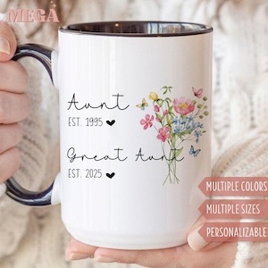 May include: White ceramic mug with a black interior and handle. The mug features the words "Aunt EST. 1995" and "Great Aunt EST. 2025" with a floral design and butterflies. The mug is personalized and available in multiple colours and sizes.