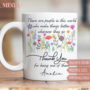 May include: White ceramic mug with a floral design and the text "There are people in this world who make things better wherever they go. Thank You... for being one of them Amelia." Features multiple colors, sizes, and personalization options.