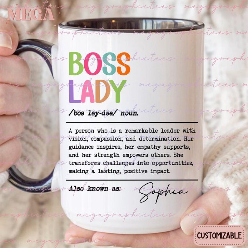 May include: White ceramic mug with a black rim and handle. The mug has a colorful graphic that says "Boss Lady" with a definition below. The definition reads: "A person who is a remarkable leader with vision, compassion, and determination. Her guidance inspires, her empathy supports, and her strength empowers others. She transforms challenges into opportunities, making a lasting, positive impact." The text "Also known as" is followed by the name "Sophia". The mug is customizable.