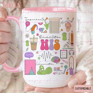 May include: White ceramic mug with a pink rim and handle. The mug features a colorful illustration of various speech therapy symbols, including a brain, ear, and sound waves. The text "Rehabilitation" and "HIS" are featured in large, colorful letters.