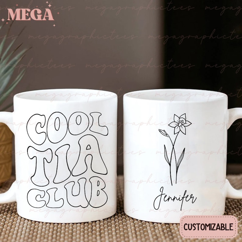 May include: Two white ceramic mugs with black designs. The mug on the left has the text "COOL TIA CLUB" in a retro font. The mug on the right has a simple line drawing of a daffodil and the name "Jennifer" written below it. The text "CUSTOMIZABLE" is printed in white on a black background below the mugs.