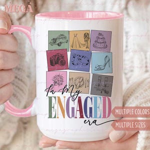 May include: White ceramic mug with a pink rim and handle. The mug features a colorful design with illustrations of wedding-related items, such as a car, a dress, rings, and a cake. The text "In my engaged era" is printed in colorful letters on the mug.