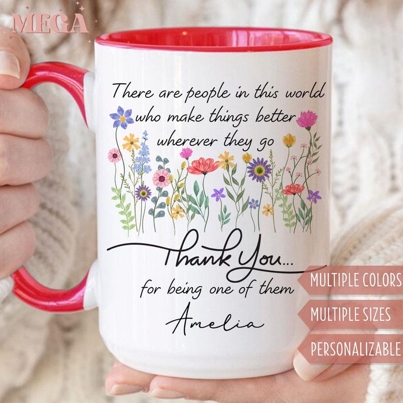 May include: White ceramic mug with a red interior and handle. The mug features a floral design with the text "There are people in this world who make things better wherever they go. Thank You... for being one of them Amelia."