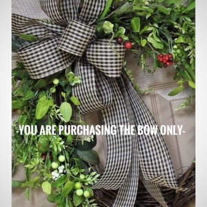 May include: A black and white checkered ribbon bow tied in a large loop with long tails. The bow is attached to a green wreath with red berries. The text "YOU ARE PURCHASING THE BOW ONLY" is visible at the bottom of the image.