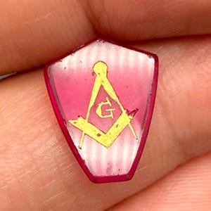 May include: A white ceramic mug with a black handle and the text "But First, Coffee" in a black, bold font. The mug is sitting on a wooden surface. The mug is approximately 4 inches tall.