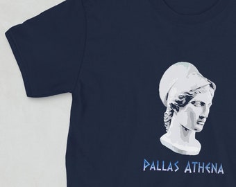 May include: Navy blue short-sleeve t-shirt featuring a white illustration of Pallas Athena, a Greek goddess, with the text "PALLAS ATHENA" in blue below the image. The shirt is made of a soft material.