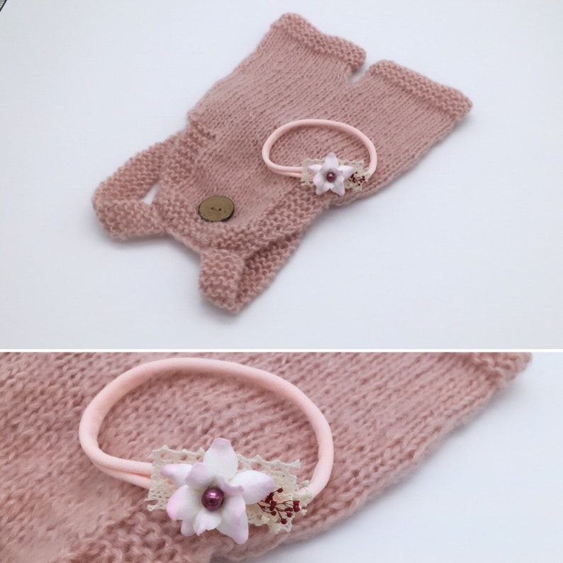 May include: A knitted baby outfit in a soft pink hue, featuring fingerless gloves with a button closure and a matching headband. The headband is adorned with a delicate flower and lace embellishment, creating a charming ensemble. The set is designed for newborns.