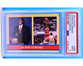 May include: A 1990 NBA Hoops trading card featuring Michael Jordan of the Chicago Bulls. The card is graded by PSA and is in mint condition. The card features a photo of Jordan in a red and black Bulls uniform, as well as a photo of him holding an award. The card also includes the text "SUPER STREAKS" and "NBA HOOPS".