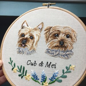 May include: Embroidered portrait of two Yorkshire Terriers, named "Cub & Mei", with a floral design featuring blue and yellow flowers.