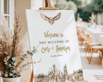 May include: A white wedding welcome sign on a wooden easel. The sign features gold lettering that reads "Welcome to the Wedding of Carly + Jonathan" with a date. An owl and castle illustration are also on the sign.