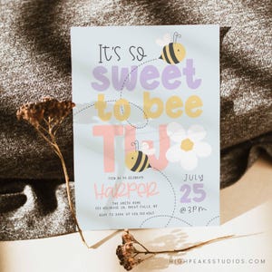 May include: A blue and white invitation card with a bee and flower design. The text reads "It's so sweet to bee two" and "Join us to celebrate Harper July 25 @ 3PM".