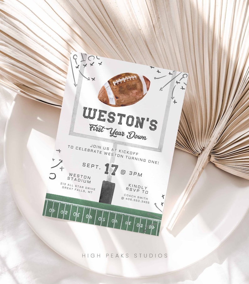 May include: A green and white football-themed invitation for a first birthday party. The invitation features a watercolor illustration of a football, a football field, and the text "Weston's First Year Down". The invitation also includes the date, time, and location of the party.