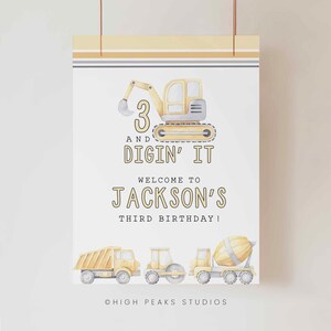 May include: A yellow and gray construction vehicle birthday party sign with the text "3 and Digin' It" and "Welcome to Jackson's Third Birthday!"