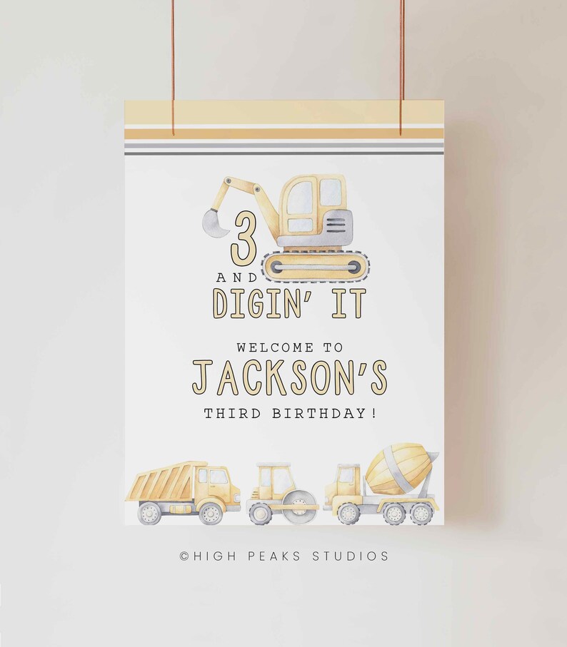May include: A yellow and gray construction vehicle birthday party sign with the text "3 and Digin' It" and "Welcome to Jackson's Third Birthday!"