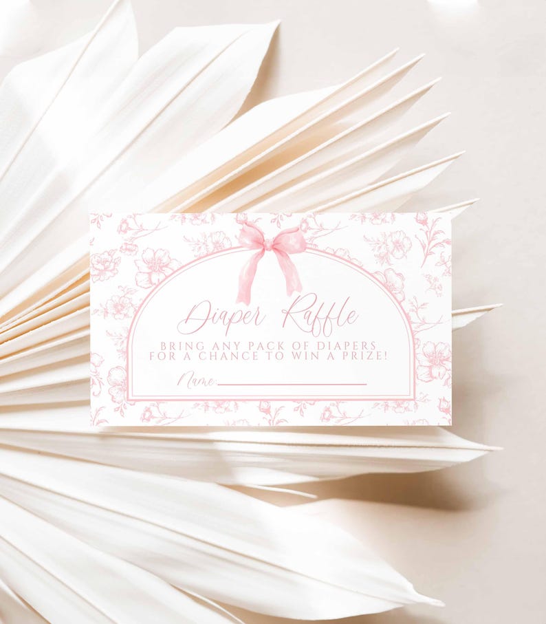 May include: A pink and white diaper raffle ticket with a floral design and a pink bow. The text reads "Diaper Raffle" and "Bring any pack of diapers for a chance to win a prize!" with a blank line for a name.