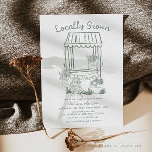 May include: A baby shower invitation with a hand-drawn illustration of a small market stand with flowers and a banner that says "Baby Anderson". The text on the invitation reads "Locally Grown" and includes the details for the baby shower, including the date, time, location, and RSVP information.