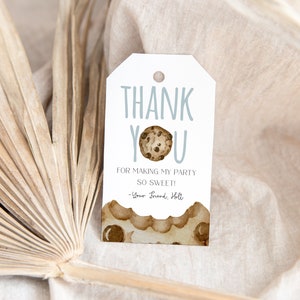 May include: A white thank you tag with blue text that says "Thank You" with a chocolate chip cookie illustration. The text below the cookie says "For making my party so sweet!" and "Your Friend, Holt".