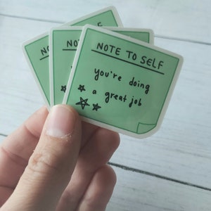 May include: Green sticker with the text "Note to Self" and the message "You're doing a great job" with three stars.
