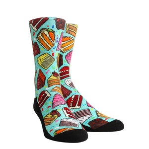 May include: A pair of blue socks with a colourful cake pattern. The socks are made of a soft, comfortable material and are perfect for everyday wear.