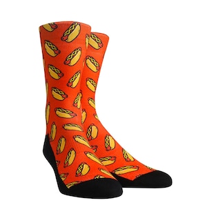 May include: A pair of orange socks with a hot dog pattern. The socks are black at the toes and heels.