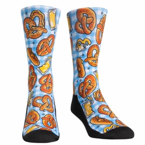 May include: Novelty socks featuring a blue and white gingham pattern, adorned with illustrations of pretzels and beer glasses. The heel and toe sections are black.